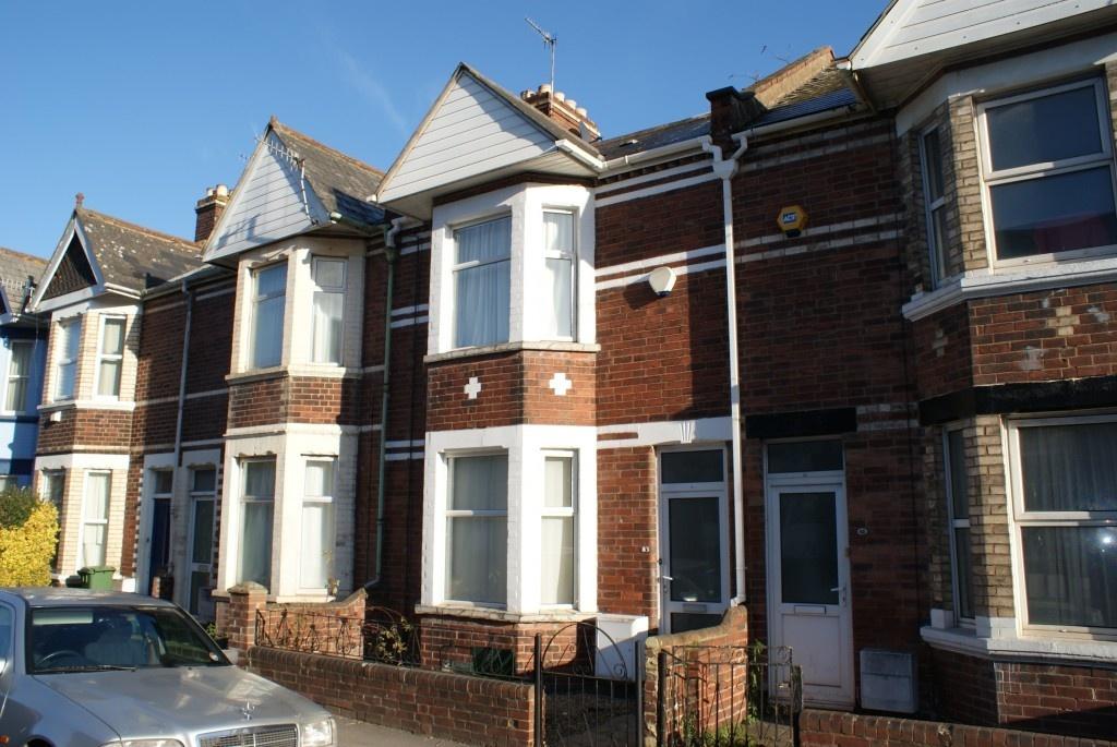 A charming terraced brick house with white-fram...