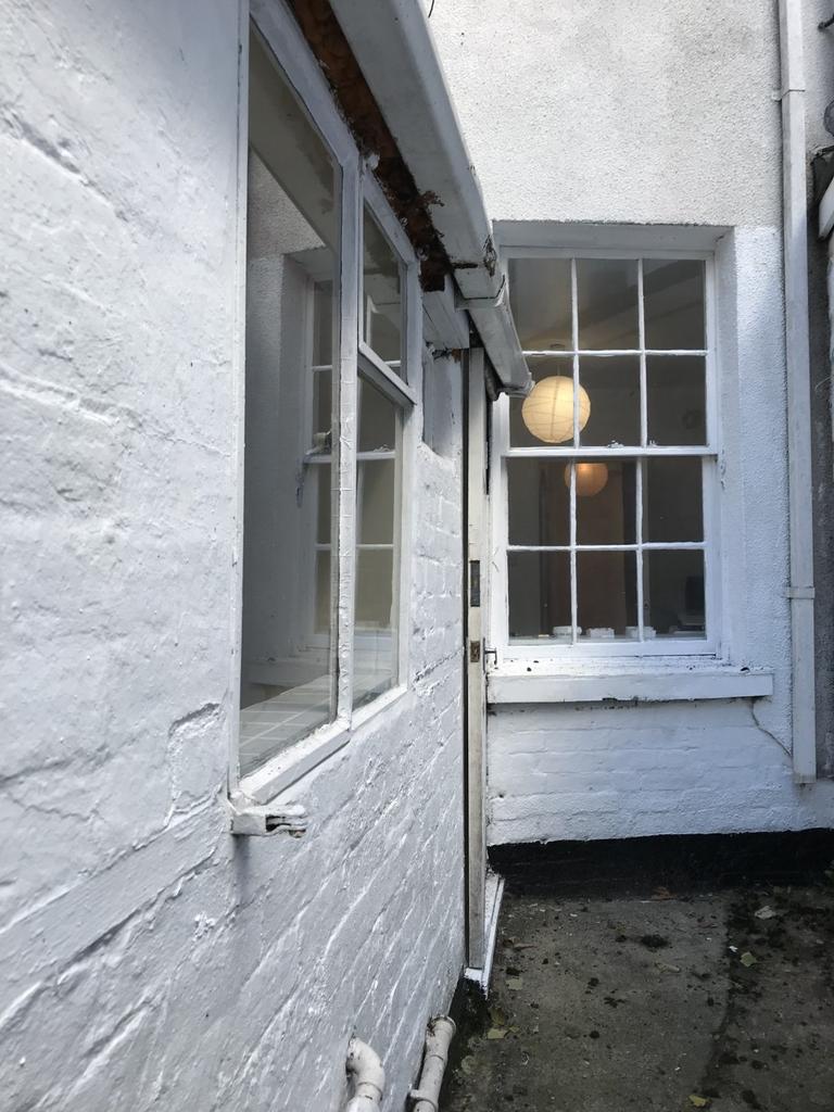 Exterior view of a terraced house featuring cla...
