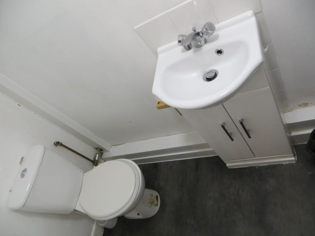 Compact and functional toilet area featuring a ...