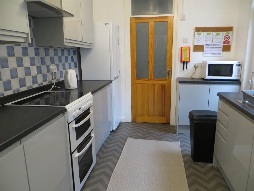 Modern kitchen with ample cabinet storage, elec...
