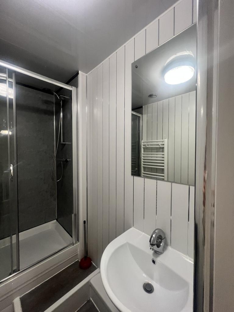 Modern bathroom featuring a sleek walk-in showe...