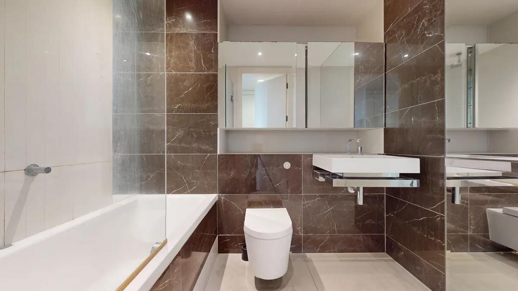 A sleek, modern bathroom suite featuring a larg...