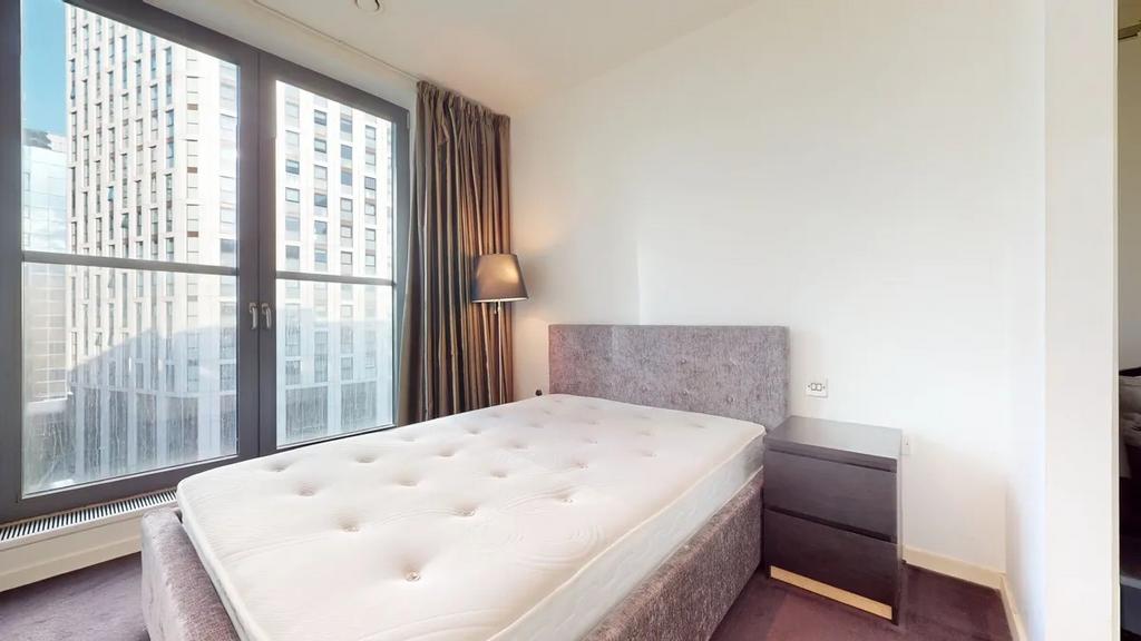 Bright and modern double bedroom featuring a co...