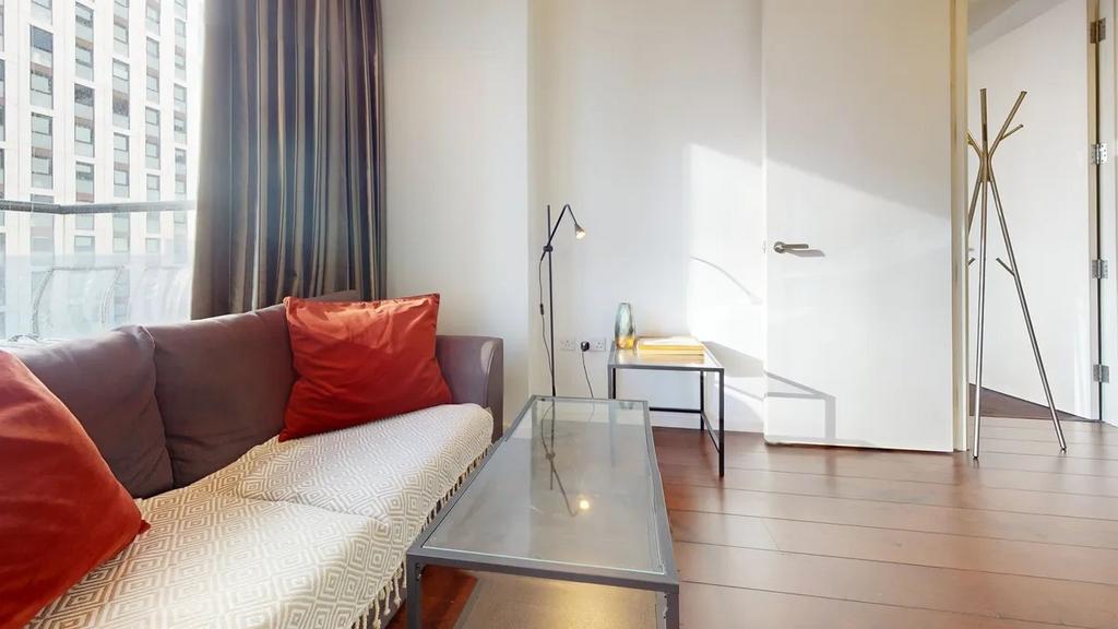 A bright and inviting living room featuring a c...