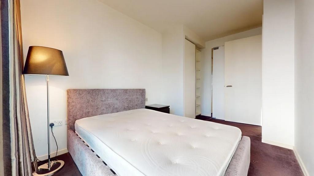 A clean and bright double bedroom featuring a p...