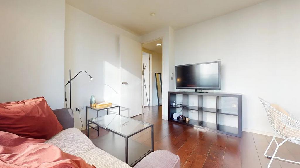 Bright and modern living room featuring a comfo...