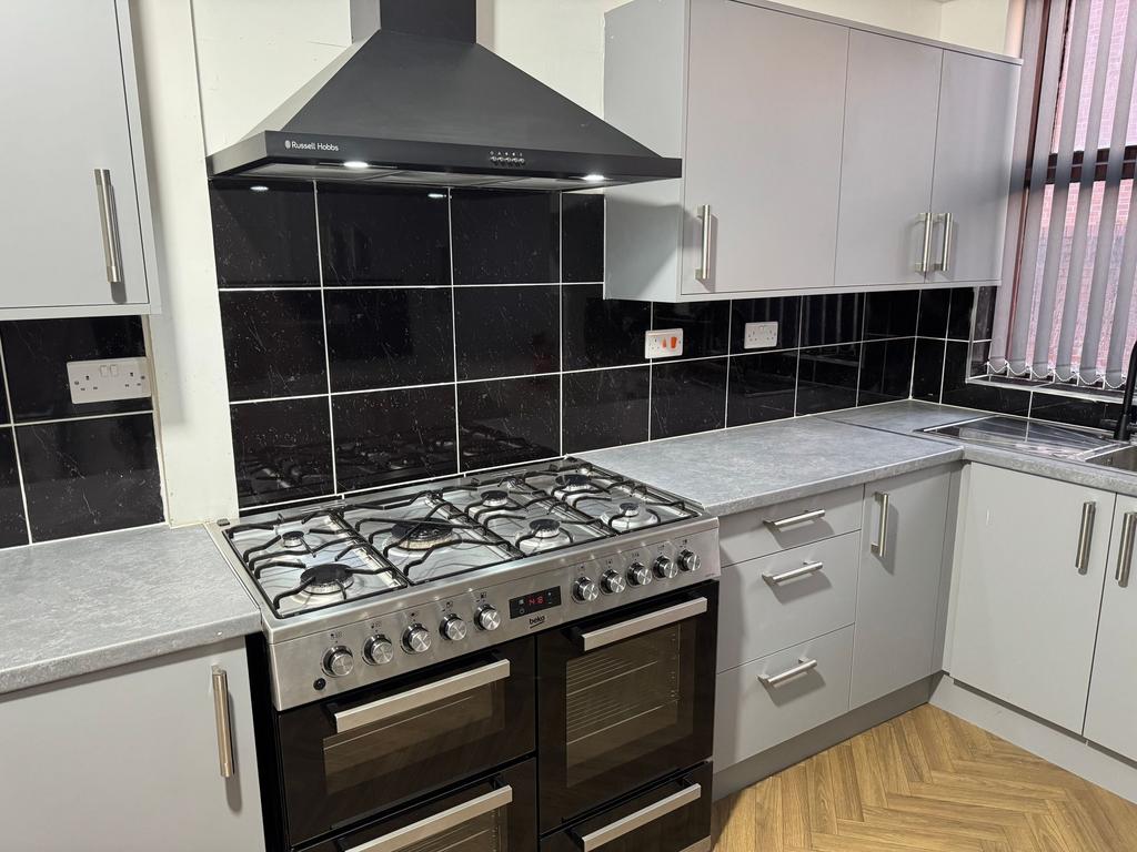 Modern kitchen featuring a large stainless stee...