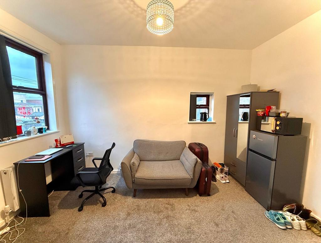 A well-maintained living room featuring cozy gr...