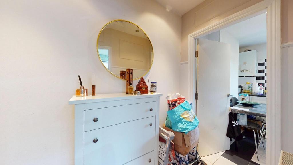 A clean and bright hallway featuring a white ch...