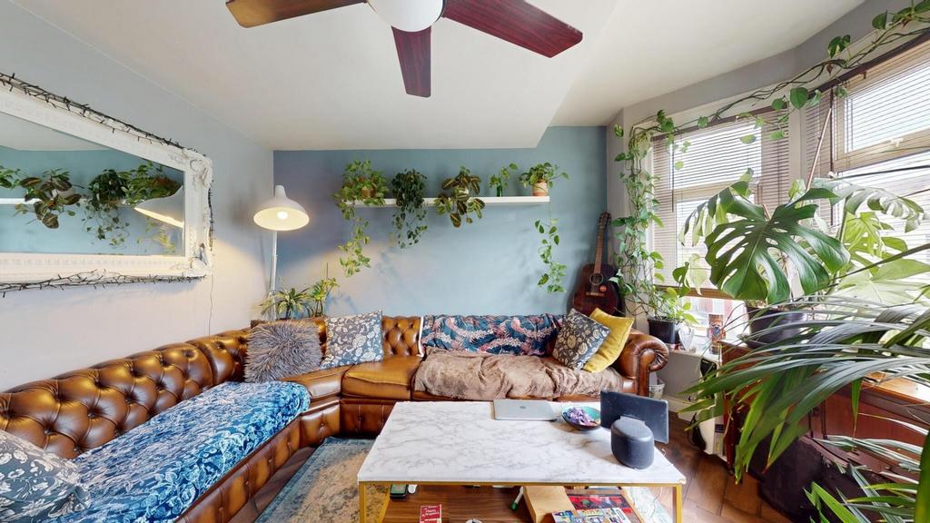 A bright and inviting living room featuring a c...