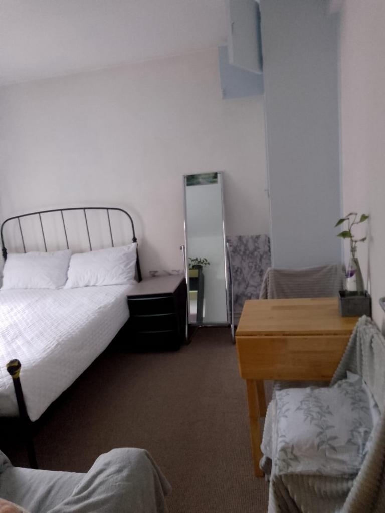 A cozy double bedroom featuring a metal bed fra...