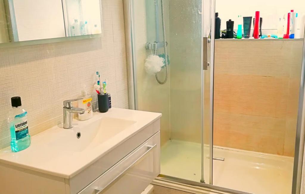Bright and modern bathroom featuring a sleek sh...
