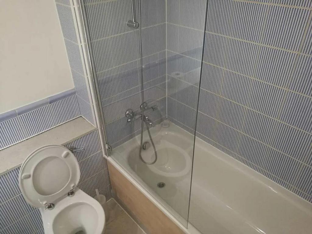 A clean and functional bathroom suite featuring...