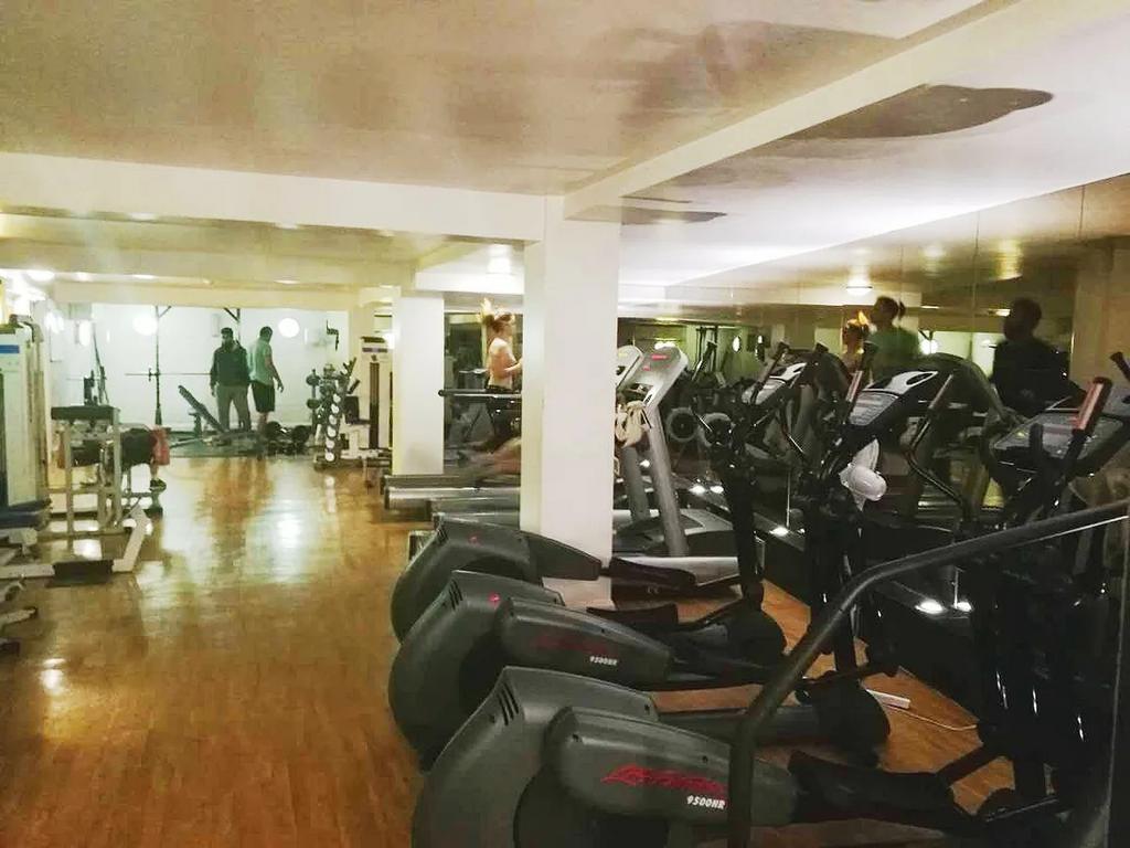 A spacious gym room featuring a variety of card...