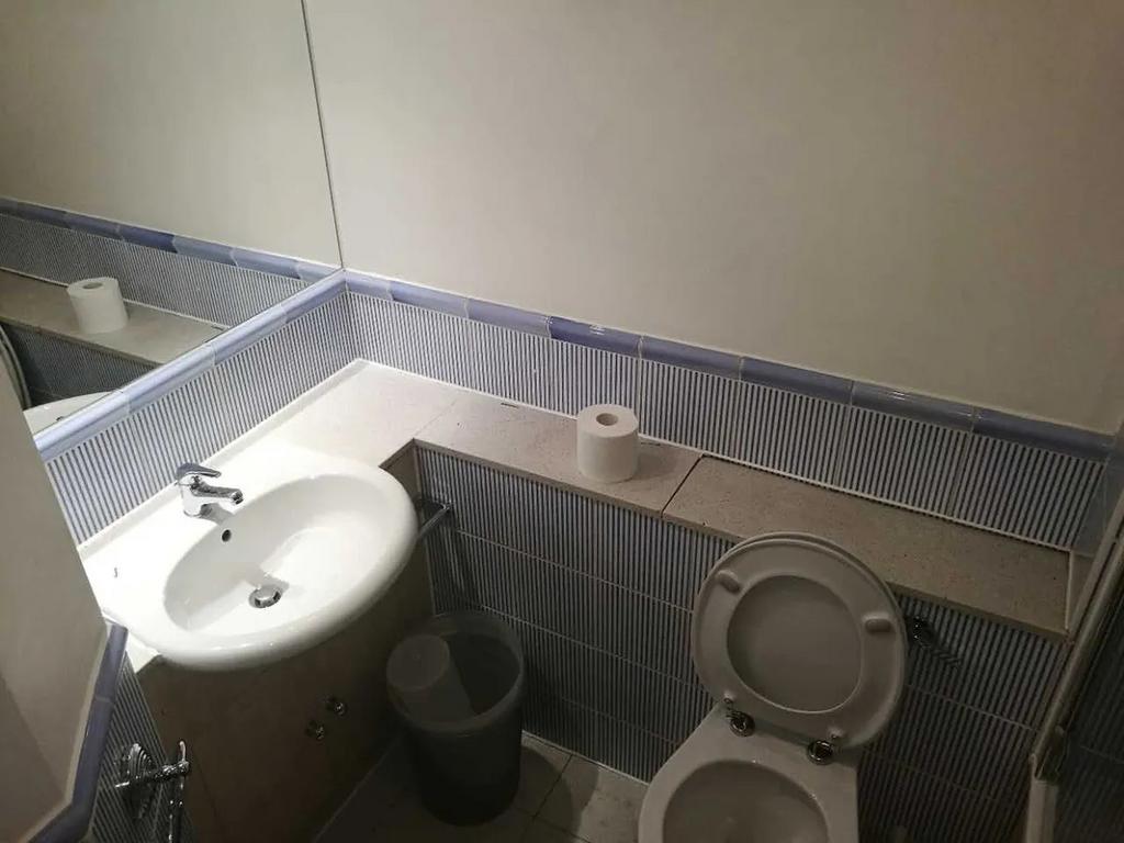 Compact and functional bathroom featuring a cle...