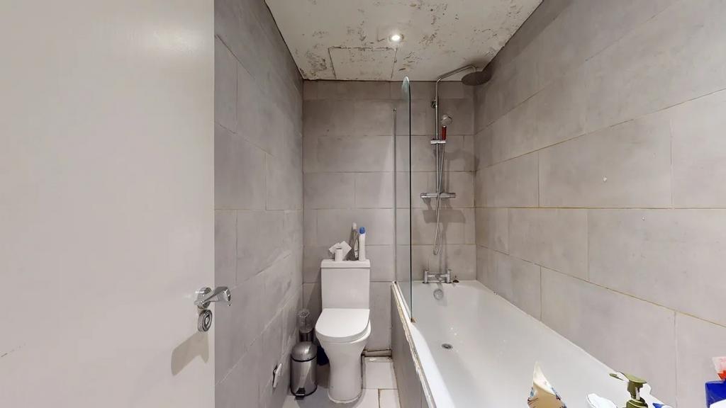 A modern bathroom featuring a clean white batht...