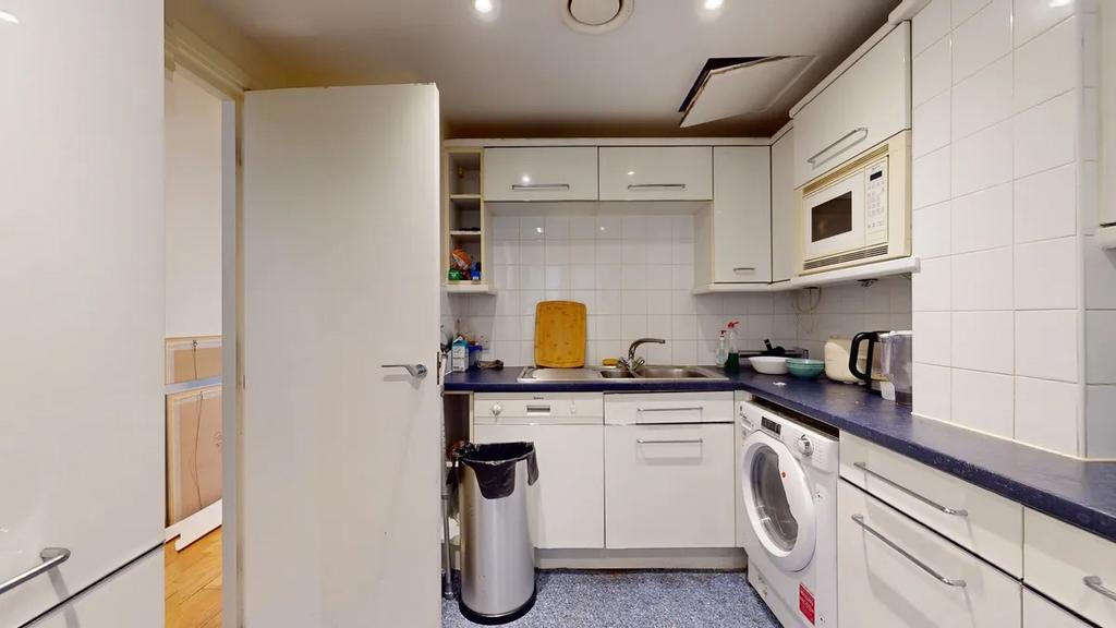 A compact, well-maintained kitchen featuring mo...