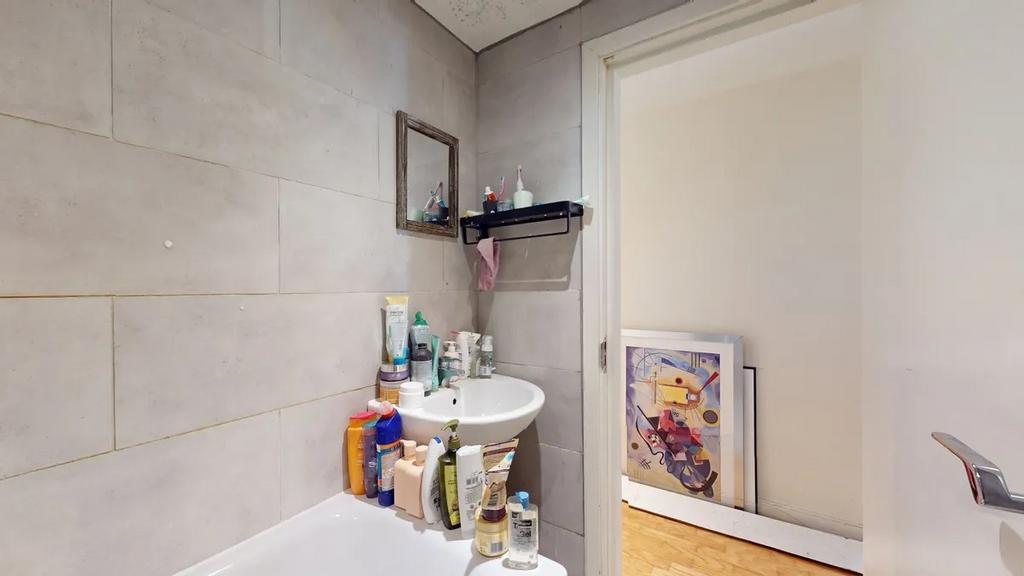 A neat and modern bathroom featuring a white si...