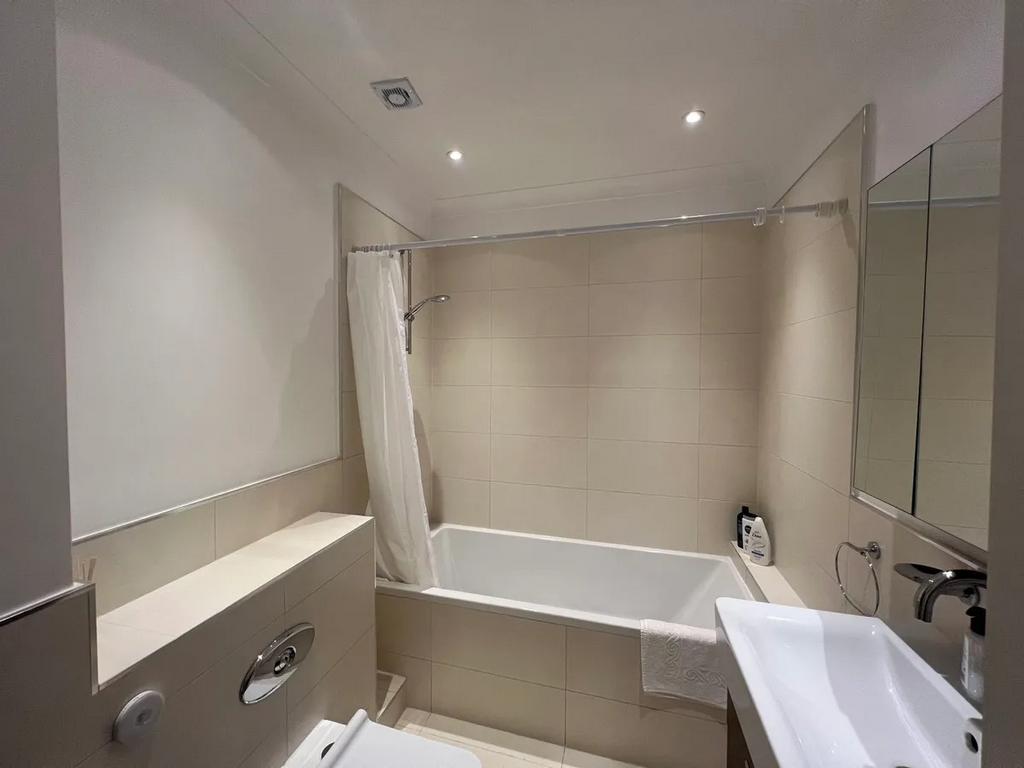 A modern bathroom suite featuring a clean white...
