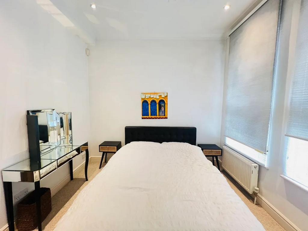 Bright and neat double bedroom featuring a comf...