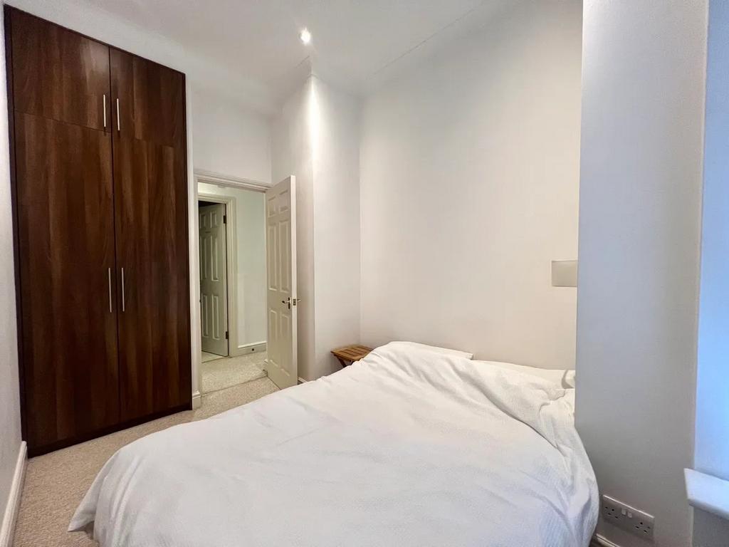A cozy double bedroom featuring a large built-i...