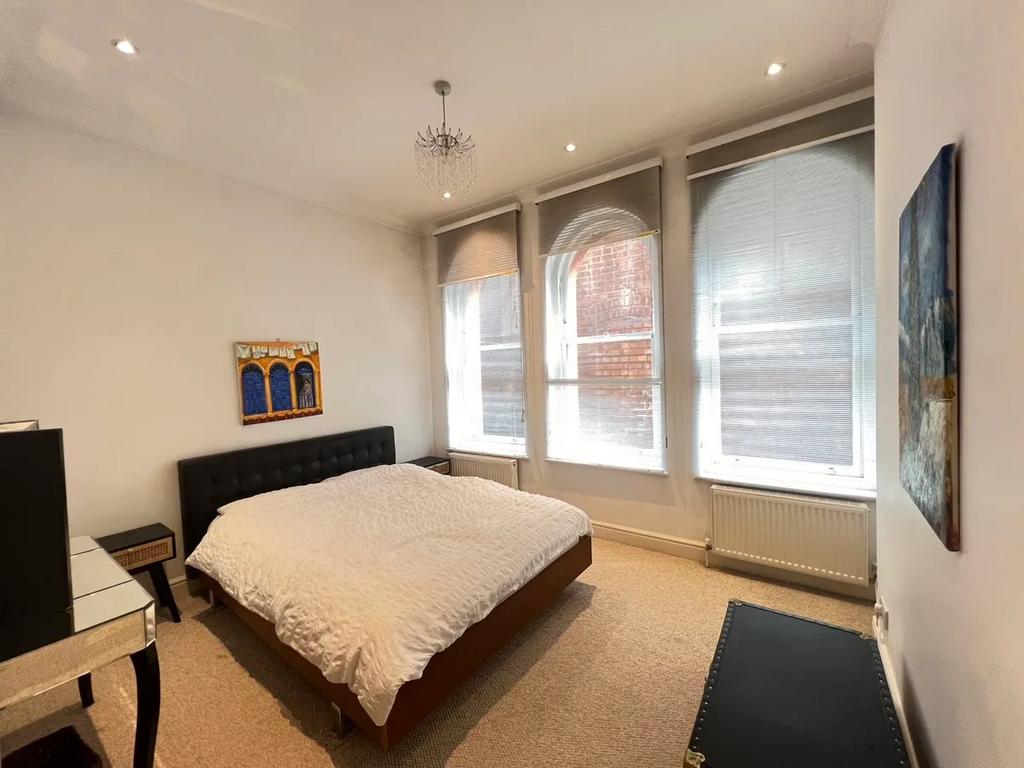 Bright and spacious master bedroom featuring th...