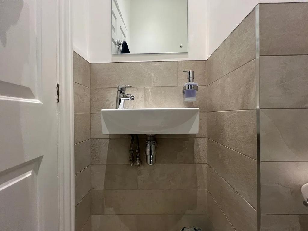 A modern and clean small single toilet area fea...