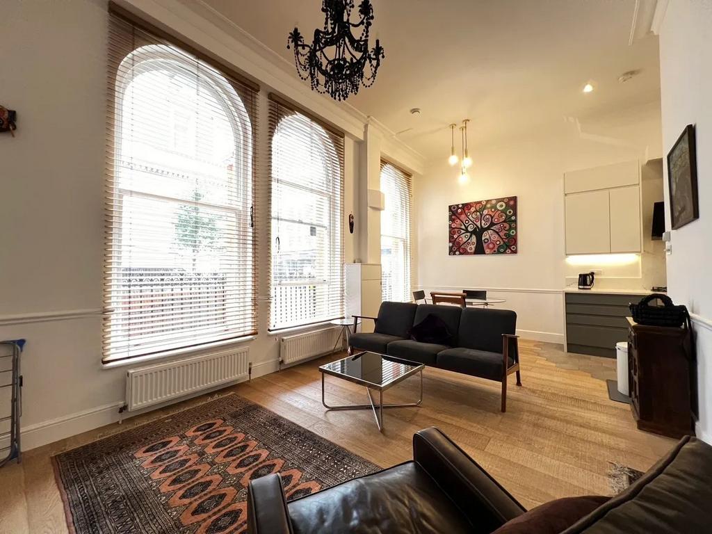 Bright and inviting living room featuring tall ...
