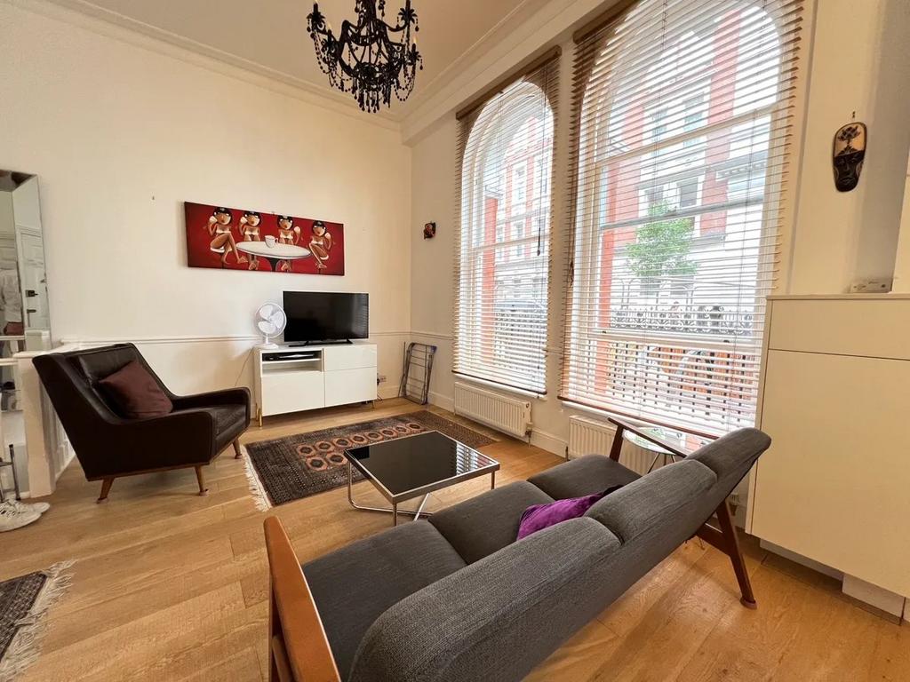 A stylish living room with large arched windows...