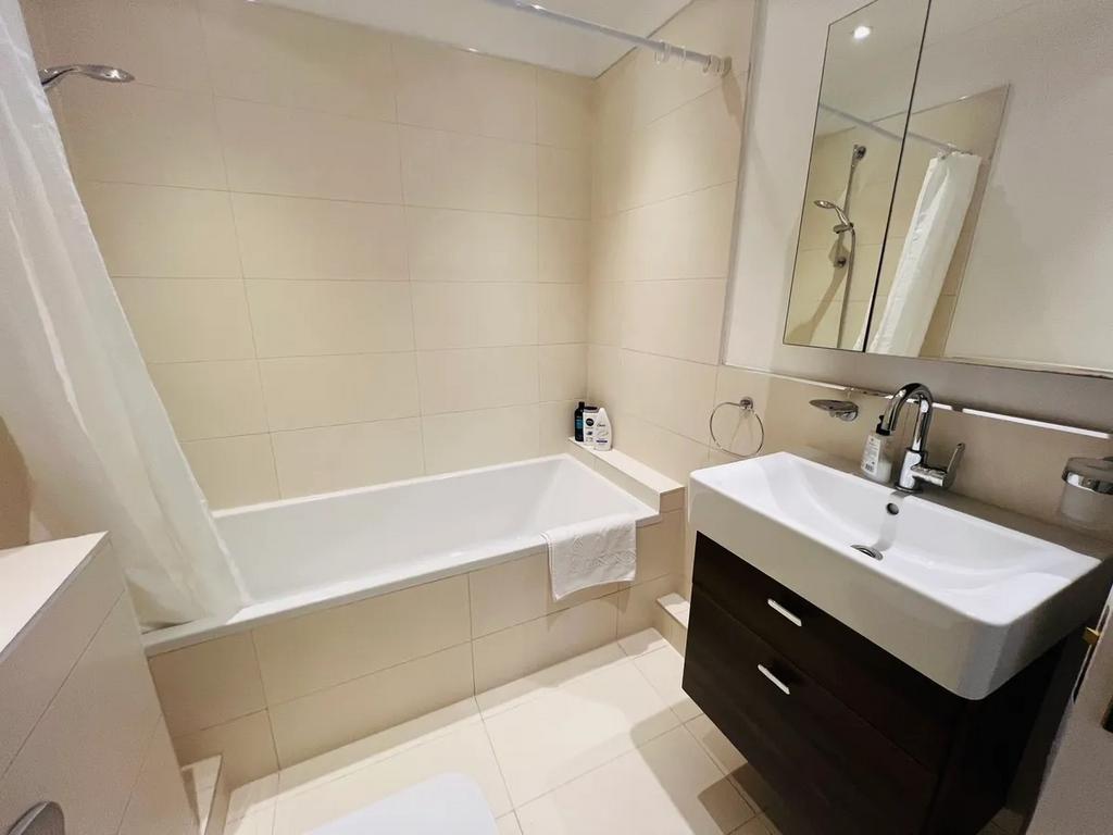 A modern bathroom suite featuring a clean white...