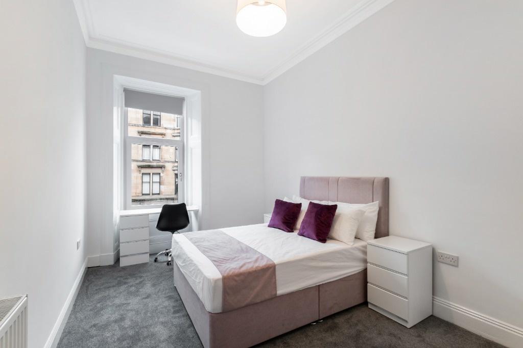 This inviting double bedroom features a comfort...