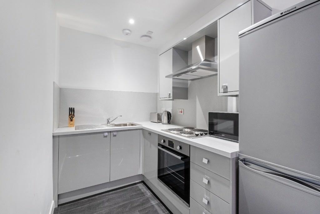 This modern kitchen features sleek cabinetry an...