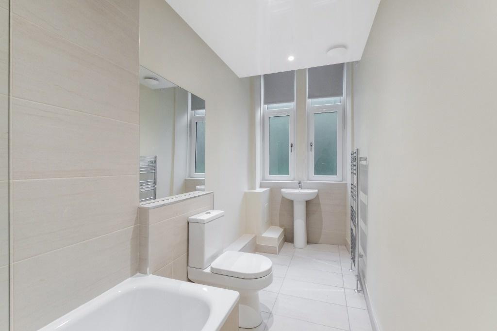 This modern bathroom features a clean design wi...