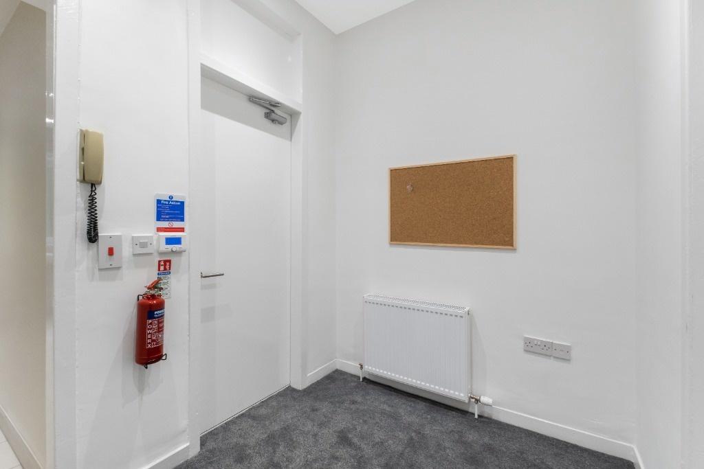 A clean and well-maintained hallway featuring a...