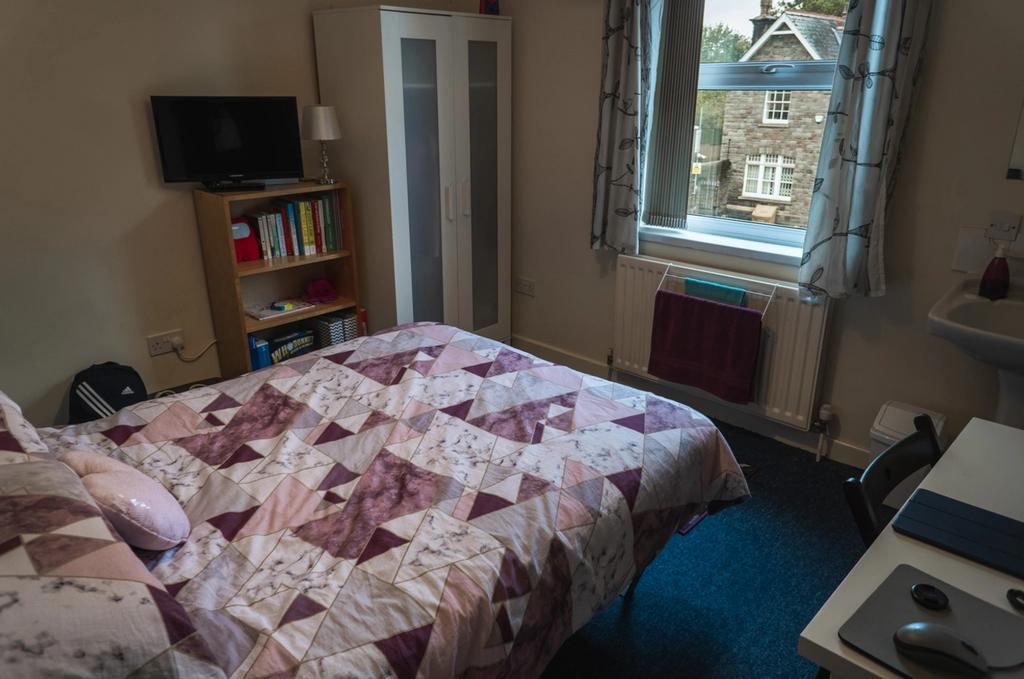 Cozy double bedroom featuring a comfortable bed...