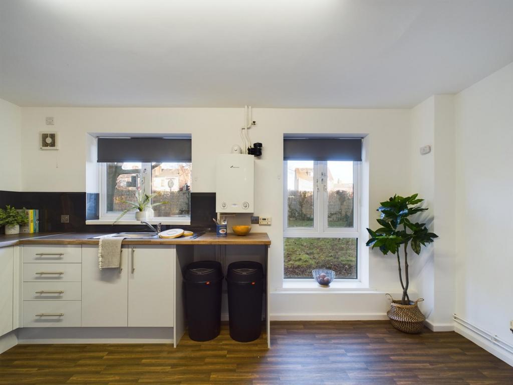 A bright and modern kitchenette with ample stor...