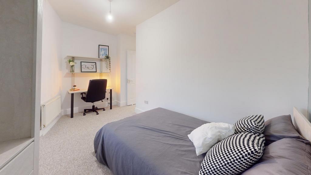 A spacious and well-lit double bedroom, featuri...