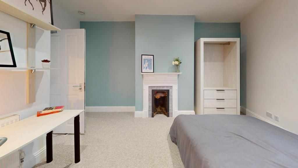 A spacious and inviting double bedroom with goo...