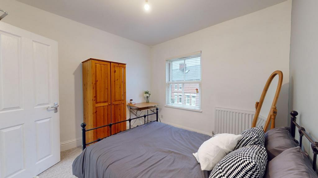 A bright and inviting double bedroom with ample...