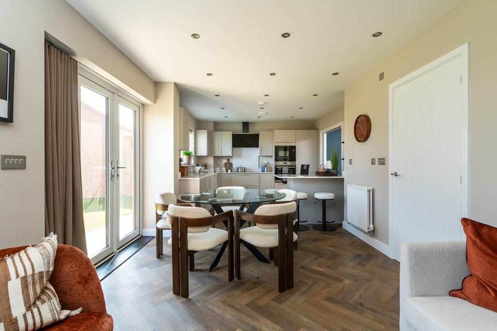The dining area flows into the garden through...