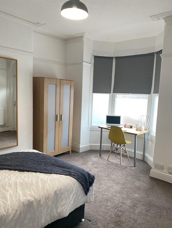 A bright and cozy double bedroom featuring a co...