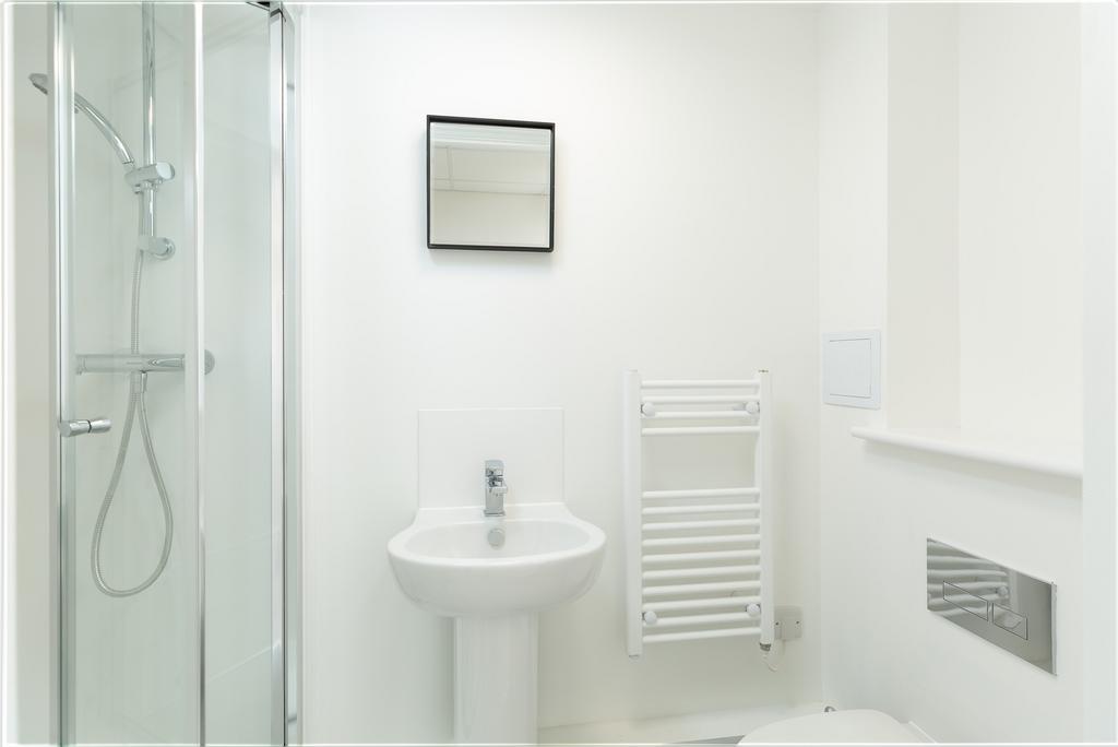 A modern and pristine bathroom featuring a spac...