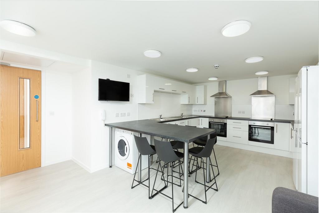 A spacious and modern kitchen with ample light,...