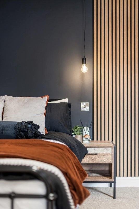 A modern double bedroom featuring a cozy bed dr...