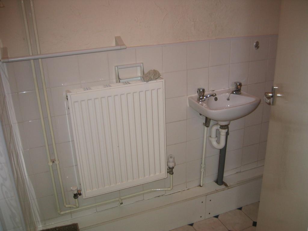A small, functional toilet area featuring a whi...