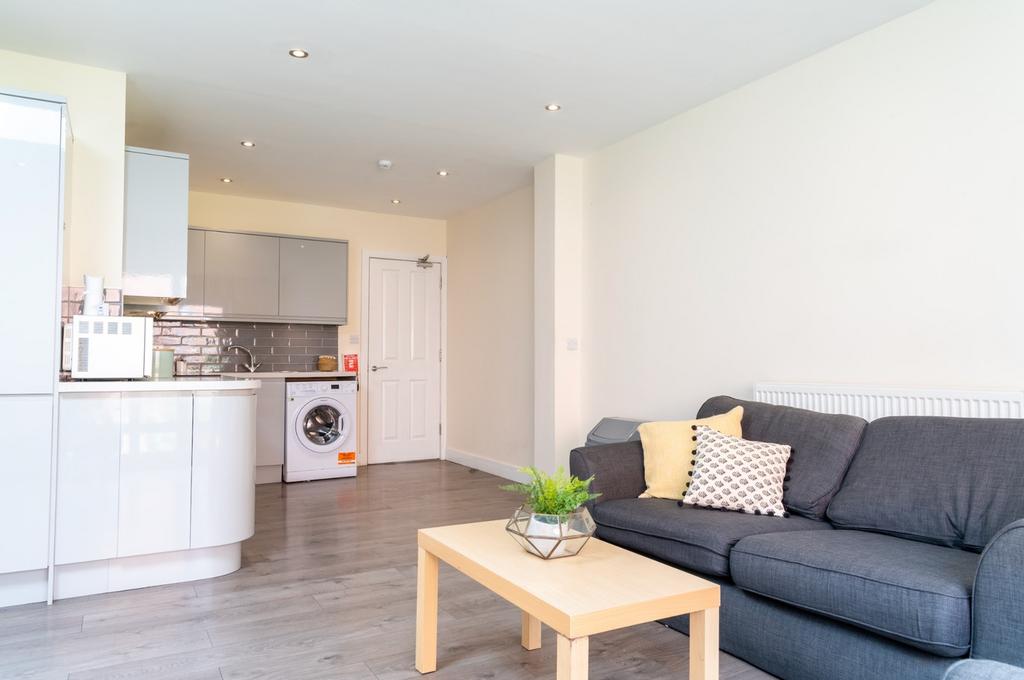 A bright and inviting living room featuring a c...