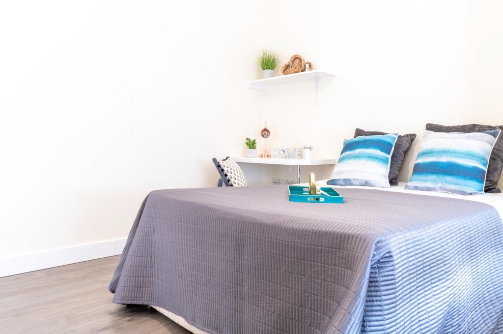 This inviting double bedroom features a cozy at...