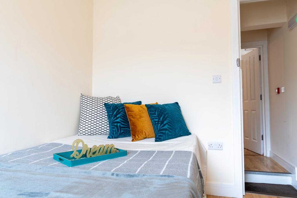 A cozy double bedroom featuring soft, inviting ...