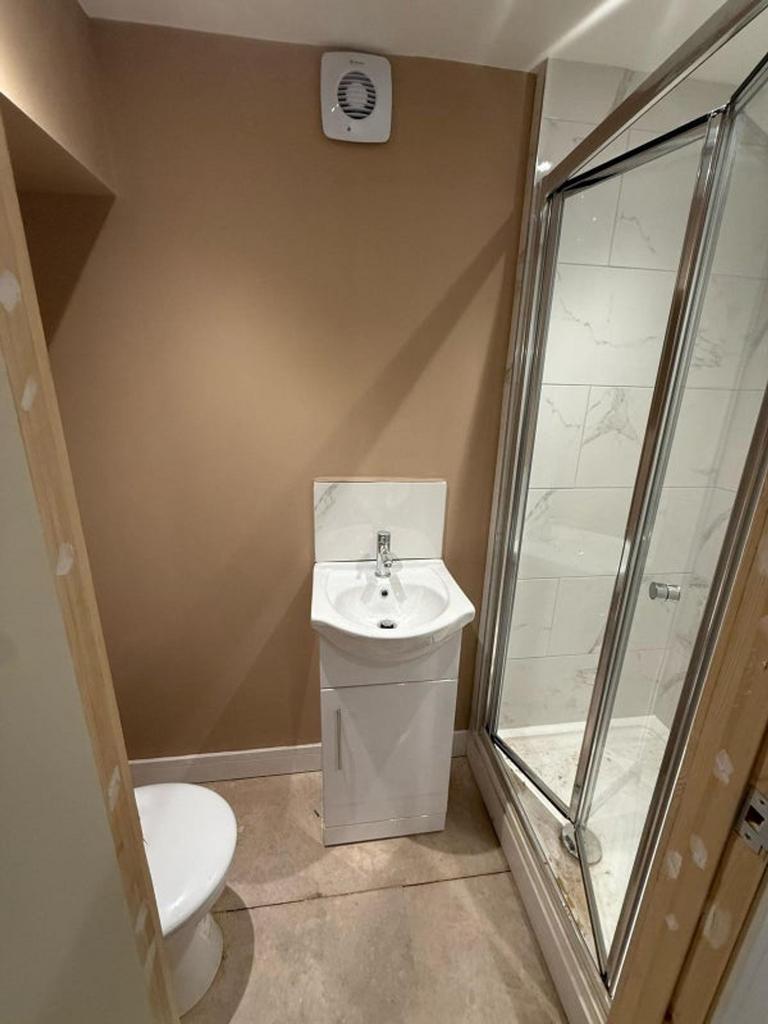 A modern bathroom featuring a sleek shower, sty...