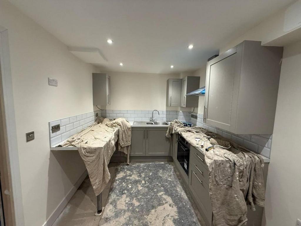 Spacious kitchen area featuring modern cabinetr...